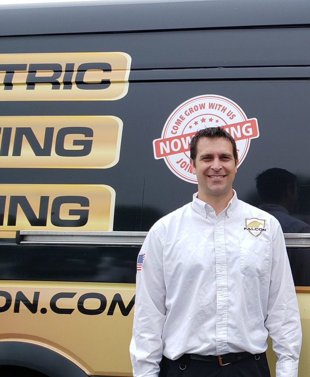 Employee in front of company truck